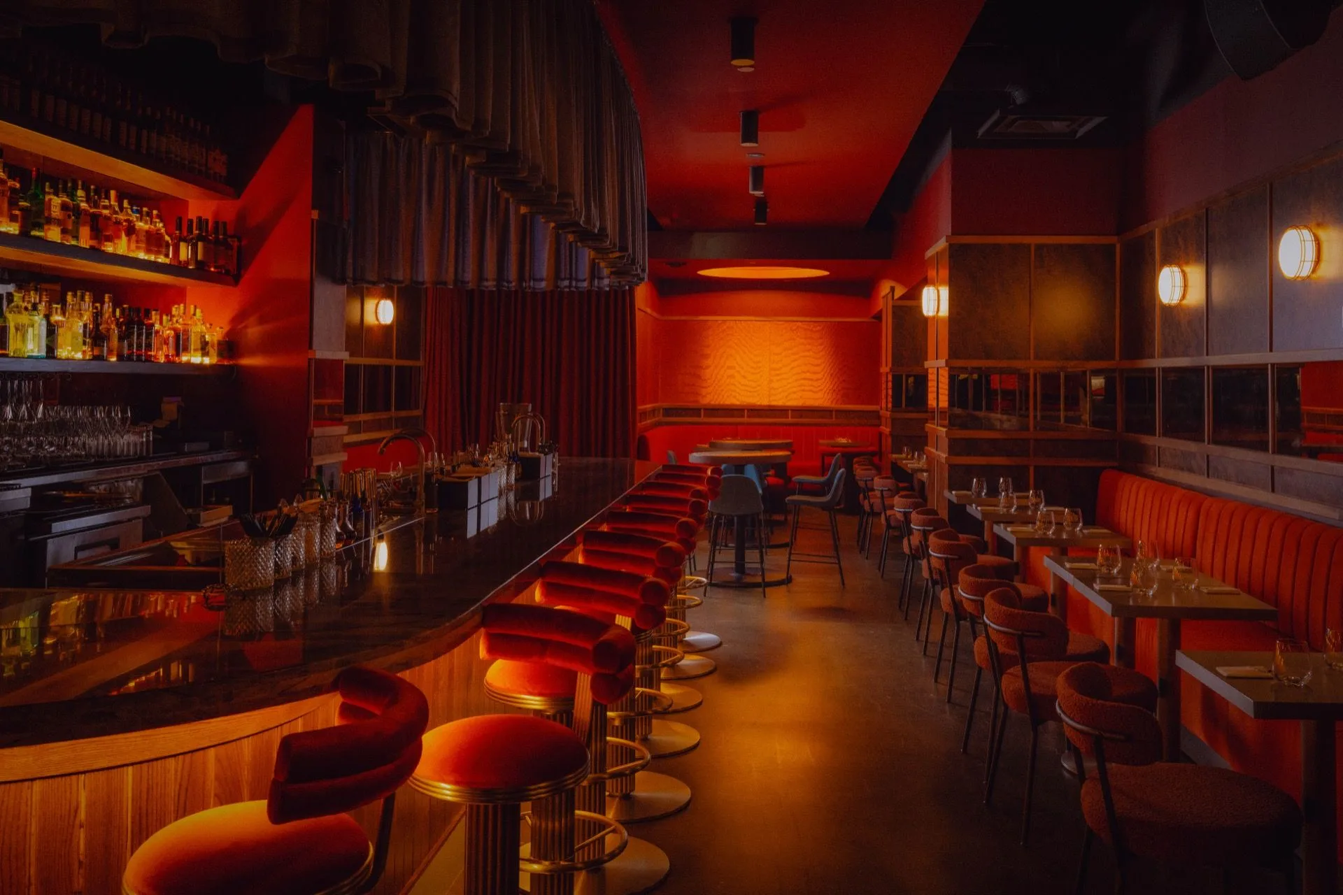The Bar Cart bar inside Eloise — red banquettes, mood lighting, the long counter